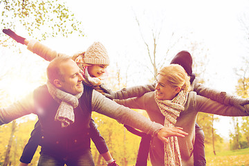 Image showing happy family having fun in autumn park