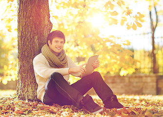 Image showing man with tablet pc in autumn park