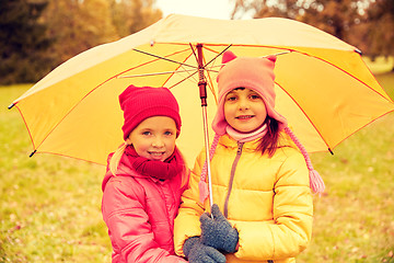 Image showing happy little girls with umbrella in autumn park