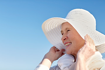 Image showing happy senior woman in sun hat on summer beach