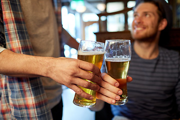 Image showing happy male friends drinking beer at bar or pub