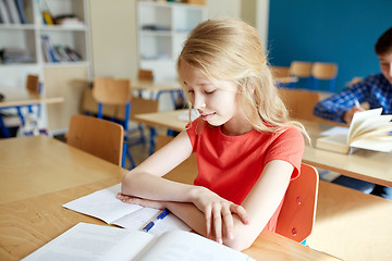 Image showing student girl with book at school lesson