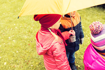 Image showing close up of kids with umbrella in autumn park