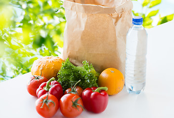 Image showing close up of paper bag with vegetables and water