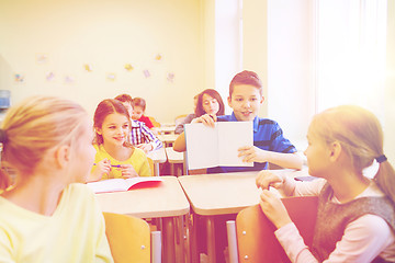 Image showing group of school kids writing test in classroom