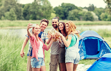 Image showing happy friends taking selfie by smartphone at camp