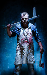 Image showing Bloody Halloween theme: crazy killer as butcher with an ax