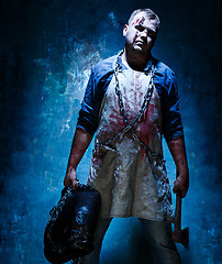 Image showing Bloody Halloween theme: crazy killer as butcher with an ax