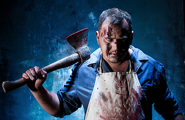 Image showing Bloody Halloween theme: crazy killer as butcher with an ax