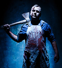 Image showing Bloody Halloween theme: crazy killer as butcher with an ax