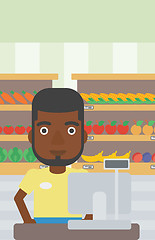 Image showing Cashier standing at the checkout in supermarket.