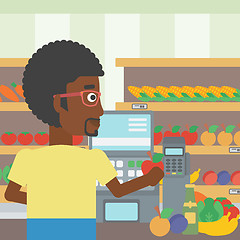 Image showing Cashier standing at the checkout in supermarket.