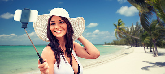 Image showing smiling young woman taking selfie with smartphone