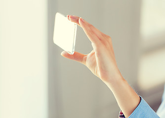 Image showing close up of woman with transparent smartphone