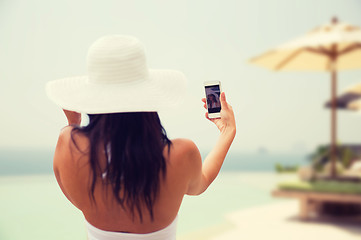 Image showing woman taking selfie with smartphone on beach