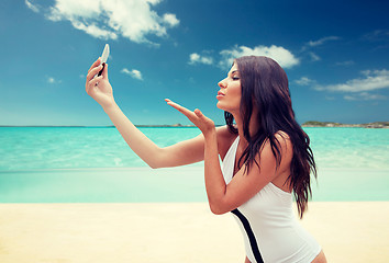 Image showing young woman taking selfie with smartphone