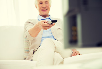 Image showing close up of happy senior woman watching tv at home