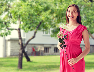 Image showing happy pregnant woman with rose flower