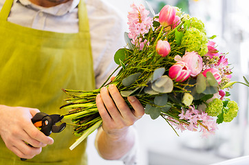 Image showing close up of florist man with flowers and pruner