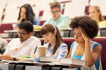 Image showing group of students with coffee writing on lecture