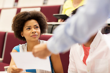 Image showing teacher giving test to student girl on lecture