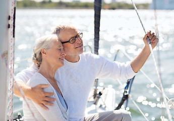 Image showing senior couple hugging on sail boat or yacht in sea