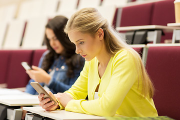 Image showing student girls with smartphones on lecture
