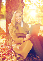 Image showing woman with tablet pc in autumn park