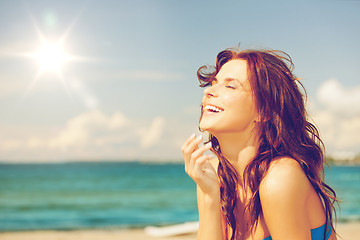 Image showing laughing woman on the beach