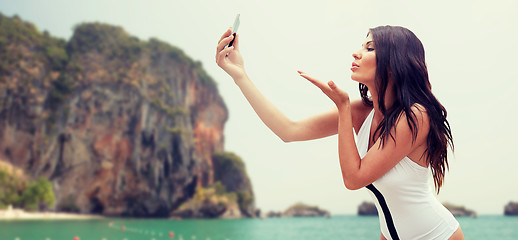 Image showing young woman taking selfie with smartphone