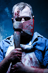 Image showing Bloody Halloween theme: crazy killer as butcher with an ax