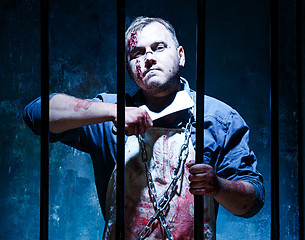 Image showing Bloody Halloween theme: crazy killer as butcher with a knife