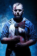 Image showing Bloody Halloween theme: crazy killer as butcher with an ax