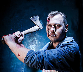 Image showing Bloody Halloween theme: crazy killer as butcher with an ax