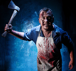 Image showing Bloody Halloween theme: crazy killer as butcher with an ax