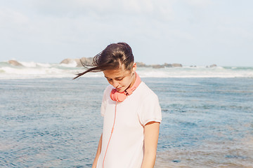 Image showing Woman walking on the beach sand