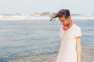 Image showing Woman walking on the beach sand