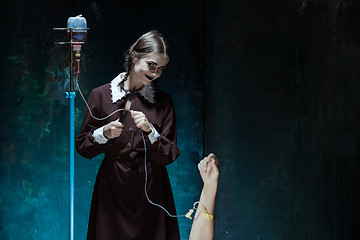 Image showing Portrait of a young girl in school uniform as killer woman