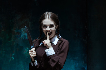 Image showing Portrait of a young girl in school uniform as killer woman