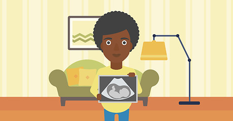 Image showing Pregnant woman with ultrasound image.