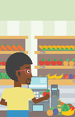 Image showing Cashier standing at the checkout in supermarket.