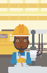 Image showing Man working on industrial drilling machine.