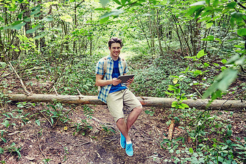 Image showing happy man with backpack and tablet pc in woods