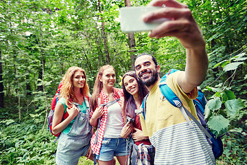 Image showing friends with backpack taking selfie by smartphone