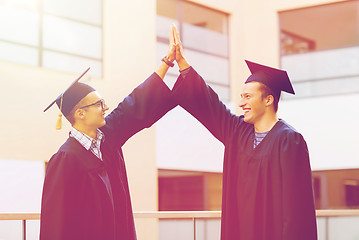 Image showing smiling students in mortarboards