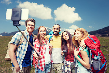 Image showing friends with backpack taking selfie by smartphone