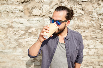 Image showing man drinking coffee from paper cup on street