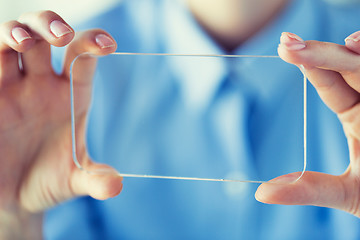 Image showing close up of woman with transparent smartphone