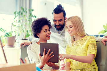 Image showing happy creative team with tablet pc in office