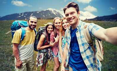 Image showing friends with backpack taking selfie in wood